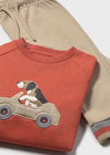 Load image into Gallery viewer, Orange sweatshirt with dog in a car design on the front plus  a pair of beige jog bottoms and a pair of grey jog bottoms. mayoral 2841 3 piece boy's tracksuit available on kidstuff.ie