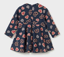 Load image into Gallery viewer, A navy blue long-sleeve dress with a playful pattern of red and beige hearts etc