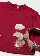 Load image into Gallery viewer, A close-up of a red long-sleeve children's top with a cute mouse character holding a pink umbrella under a fluffy white cloud applique on the chest. A matching patterned fabric hair accessory is shown.