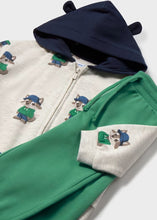 Load image into Gallery viewer, A children's zip-up hoodie and matching sweatpants The hoodie is off-white with a navy hood and small animal illustrations wearing green and blue outfits.