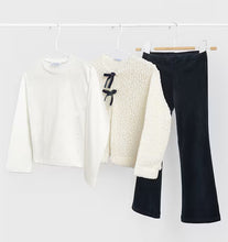 Load image into Gallery viewer, Three children's clothing items hanging on white hangers from a white rail: a cream long-sleeve top with tiny scattered dots, an off-white textured cardigan with navy bow details, and navy pants.