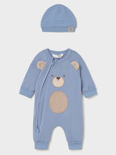 Load image into Gallery viewer, A baby's long-sleeve footless romper in dusty blue, featuring a teddy bear face applique on the front, shown with a matching blue beanie hat