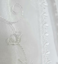 Load image into Gallery viewer, A beautiful three piece Christening outfit comprising a simple white satin gown with cap sleeves, an embroidered organza lace effect "coat" to wear over it, and a matching bonnet. The "coat"  has puff sleeves decorated with bows. It is fastened with pearl buttons and loops and is edged in guipure style lace trimming. The bonnet is fastened with velcro and is edged with a pretty organza frill. buy online on kidstuff.ie