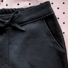 Load image into Gallery viewer, Pink polka dot sweatshirt with penguin motif and matching black jog bottoms for a girl, Milon set 13501 available on kidstuff.ie Jog bottoms detail