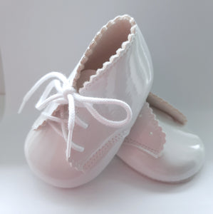 White baby shoes. Lace-up baby booties. Patent imitation leather baby christening shoes available on kidstuff.ie