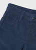 Close-up of dark blue corduroy trousers showing the waistband, belt loops, front pocket, and a dark metal button .