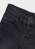 Close-up of a pair of black washed denim jeans showing the waistband, belt loops, right front pocket, 