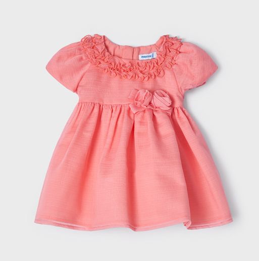 A beautiful dress for a baby or toddler girl in coral pink . High-waisted style . Short puff sleeves and  neckline  decorated with ruffles. Waist embellished with fabric bow two roses Net underneath. Centre back concealed zipper. Buy online kidstuff.ie Made by Mayoral