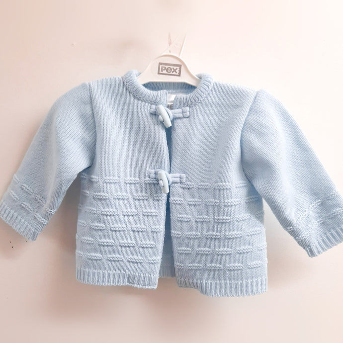 Blue baby cardigan. Pex blue baby cardigan. fastened with toggle buttons available on kidstuff.ie