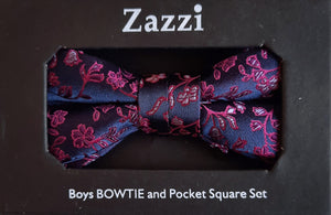 Boy's bow tie and pocket square in purple brocade patterned with an all-over design in magenta. The necktie is on an adjustable band for a comfortable fit from about 7 years to 14 years and has a hook and bar fastening. Suitable for special occasions including First Communions and weddings