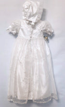 Load image into Gallery viewer, A beautiful three piece Christening outfit comprising a simple white satin gown with cap sleeves, an embroidered organza lace effect &quot;coat&quot; to wear over it, and a matching bonnet. The &quot;coat&quot;  has puff sleeves decorated with bows. It is fastened with pearl buttons and loops and is edged in guipure style lace trimming. The bonnet is fastened with velcro and is edged with a pretty organza frill. Buy on;ine on kidstuff.ie
