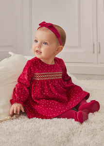 Baby girl's red velvet dress with long sleeves and smocking detail. Mayoral 2808 red velvet dress. Available on kidstuff.ie Christmas dress.
